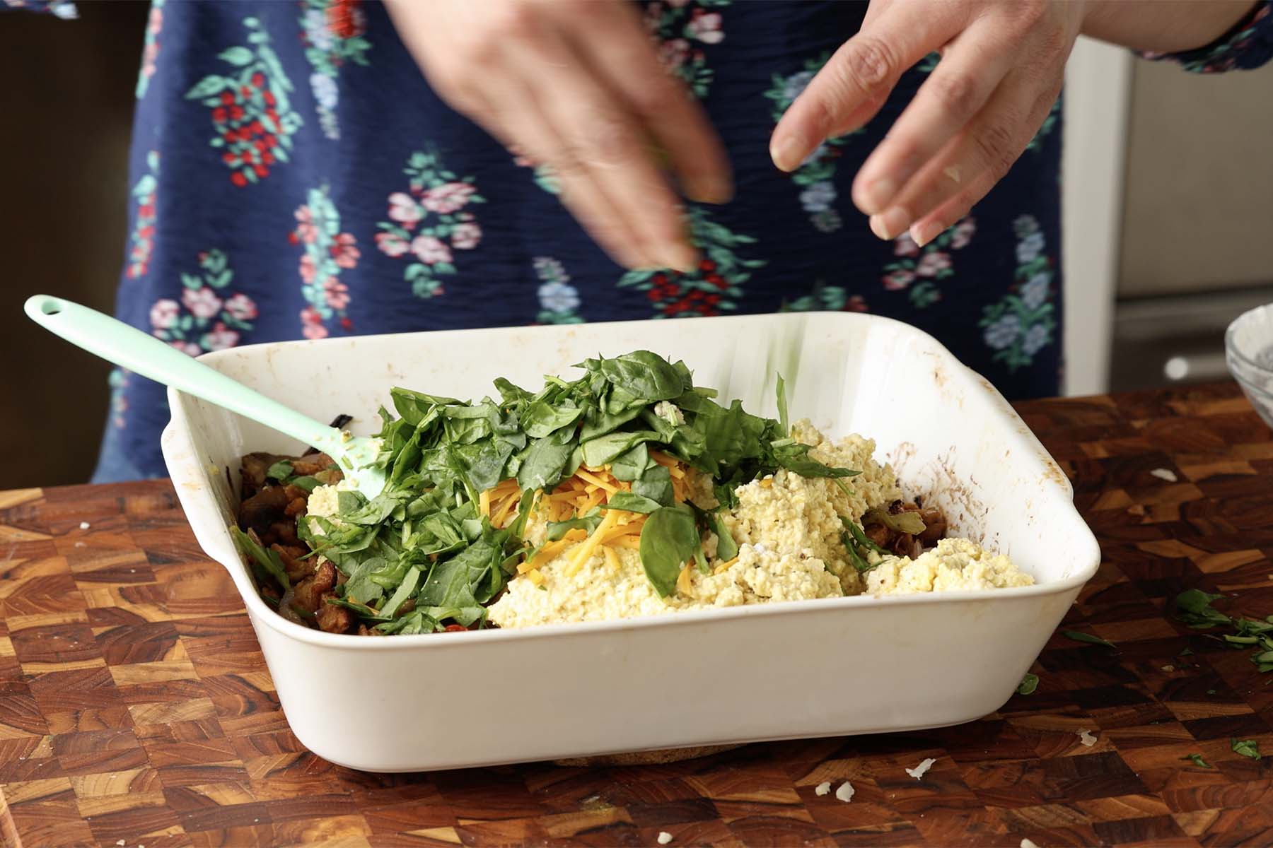 adding veggies to the pan with the tofu mixture