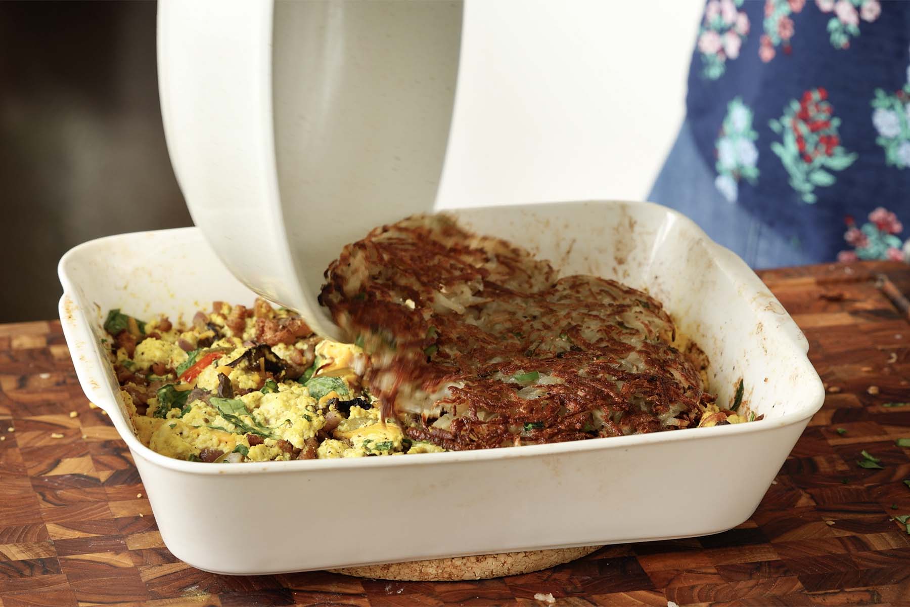 topping the casserole with the hashbrowns