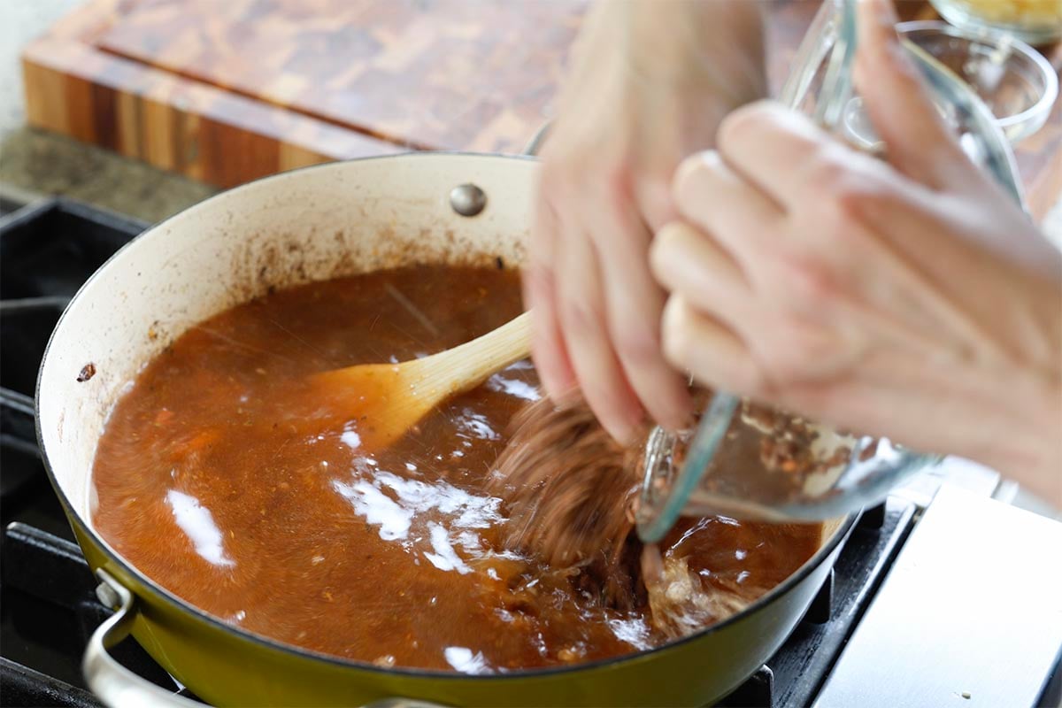 adding lentils to the pan