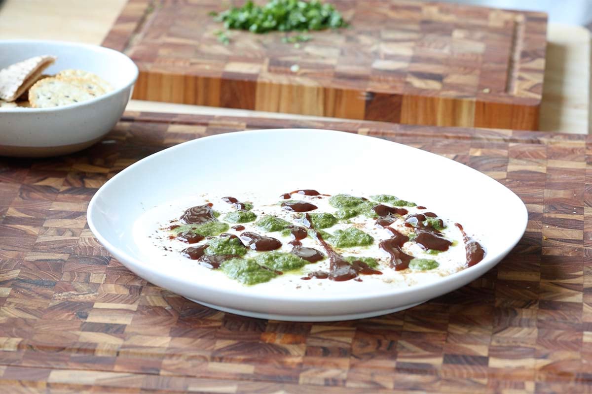 adding yogurt, spices, and chutney to the plate